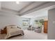 Main bedroom featuring a tray ceiling, neutral walls, carpet flooring, and large windows at 5101 Barrington Trace Dr, Atlanta, GA 30331