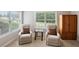 Comfortable sitting room with two cushioned chairs, small table, and light-filled windows at 5101 Barrington Trace Dr, Atlanta, GA 30331