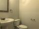 Powder room featuring a pedestal sink, toilet, and towel bar at 1282 Ainsworth Aly, Sugar Hill, GA 30518