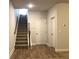 Inviting entryway with hardwood floors, staircase, and convenient access to storage at 1282 Ainsworth Aly, Sugar Hill, GA 30518