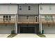 Townhome exterior showcasing a private deck and convenient garage access at 1282 Ainsworth Aly, Sugar Hill, GA 30518