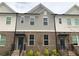 Charming townhome exterior with brick facade, gray siding, and inviting entryway at 1282 Ainsworth Aly, Sugar Hill, GA 30518