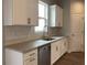 Well-lit kitchen with granite countertops, stainless steel appliances, and white cabinets at 1282 Ainsworth Aly, Sugar Hill, GA 30518