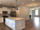 Modern kitchen with stainless steel appliances, granite countertops and a large island at 1282 Ainsworth Aly, Sugar Hill, GA 30518