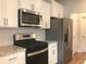 Modern kitchen featuring stainless steel appliances and granite countertops at 1282 Ainsworth Aly, Sugar Hill, GA 30518