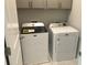 Well-lit laundry room featuring modern white appliances and stylish floors at 1282 Ainsworth Aly, Sugar Hill, GA 30518