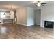 Open floor plan seamlessly connects the living room with fireplace to the modern kitchen at 1282 Ainsworth Aly, Sugar Hill, GA 30518
