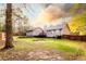 View of a large backyard, fenced perimeter, and detached garage, perfect for outdoor living and entertaining at 20 Riverbrooke Rd, Covington, GA 30016