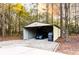 Large carport providing ample covered parking and storage space, surrounded by natural landscape at 20 Riverbrooke Rd, Covington, GA 30016