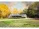 Inviting home with spacious front yard and long driveway, surrounded by mature trees at 20 Riverbrooke Rd, Covington, GA 30016