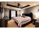 Relaxing main bedroom with tray ceiling, fan, and ample space at 20 Riverbrooke Rd, Covington, GA 30016