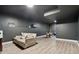 Finished basement with light wood floors and a cozy seating area at 320 Creek Side Ct, Mcdonough, GA 30252