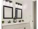 Bathroom features double sinks with decorative mirrors and lighting at 320 Creek Side Ct, Mcdonough, GA 30252