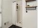 White tiled shower with black accents and industrial-style shelving for storage at 320 Creek Side Ct, Mcdonough, GA 30252