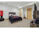 Basement bedroom featuring a rustic wood bed frame and neutral carpet at 320 Creek Side Ct, Mcdonough, GA 30252