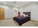 A basement bedroom featuring neutral carpet and a rustic-style bed frame at 320 Creek Side Ct, Mcdonough, GA 30252