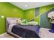 Charming bedroom featuring a green accent wall and neutral carpet at 320 Creek Side Ct, Mcdonough, GA 30252