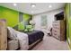 bedroom featuring green wall design, neutral carpet, and natural light at 320 Creek Side Ct, Mcdonough, GA 30252