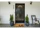Charming front door with decorative plants and a welcome mat at 320 Creek Side Ct, Mcdonough, GA 30252