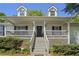 Welcoming front porch with detailed woodwork and a well-maintained yard at 320 Creek Side Ct, Mcdonough, GA 30252