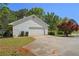 Detached two-car garage with a paved driveway and green lawn at 320 Creek Side Ct, Mcdonough, GA 30252