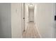 Bright hallway with light wood floors and doors on either side at 320 Creek Side Ct, Mcdonough, GA 30252