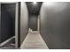 Hallway featuring grey walls and wood-look floors leading towards a doorway at 320 Creek Side Ct, Mcdonough, GA 30252