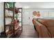 Cozy living room with stylish shelving and a comfortable reclining couch at 320 Creek Side Ct, Mcdonough, GA 30252