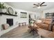 Inviting living room with fireplace, cozy recliners, and open floor plan at 320 Creek Side Ct, Mcdonough, GA 30252