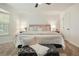Bright bedroom with neutral tones, large bed, and tufted ottoman bench at 320 Creek Side Ct, Mcdonough, GA 30252