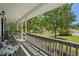 Covered front porch with seating and decorative plants at 320 Creek Side Ct, Mcdonough, GA 30252
