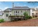 Exterior of the home showing a deck, lush greenery, and a well-maintained lawn at 4847 Sara Creek Way, Sugar Hill, GA 30518