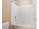 Bright bathroom features a white tiled shower and bathtub combination at 4847 Sara Creek Way, Sugar Hill, GA 30518
