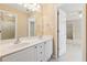 Bathroom with double sinks, white cabinets, and access to an adjacent room at 4847 Sara Creek Way, Sugar Hill, GA 30518