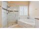 Elegant bathroom with glass shower, soaking tub, and stylish tile work at 4847 Sara Creek Way, Sugar Hill, GA 30518