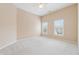 Bright bedroom with neutral walls, carpet floors, and large windows providing natural light at 4847 Sara Creek Way, Sugar Hill, GA 30518