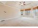 Large bedroom features tray ceiling, carpet floors, and double windows overlooking a wooded area at 4847 Sara Creek Way, Sugar Hill, GA 30518