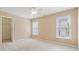 Bedroom with neutral walls, carpet, two windows, and ceiling fan at 4847 Sara Creek Way, Sugar Hill, GA 30518