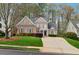 Beautiful brick home with a well-manicured lawn and a spacious driveway at 4847 Sara Creek Way, Sugar Hill, GA 30518