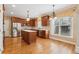 Well-lit kitchen featuring stainless steel appliances, central island, and hardwood floors at 4847 Sara Creek Way, Sugar Hill, GA 30518