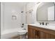 Bathroom with modern vanity, arched mirror, and subway-tiled shower at 508 Cumberland Se Ct, Smyrna, GA 30080