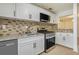 Updated kitchen featuring granite countertops, stainless steel appliances, and stylish backsplash at 508 Cumberland Se Ct, Smyrna, GA 30080