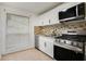 Well-lit kitchen with stainless steel appliances, granite countertops, and white cabinets at 508 Cumberland Se Ct, Smyrna, GA 30080