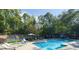 Sparkling pool with lounge chairs and a tennis court in the background at 508 Cumberland Se Ct, Smyrna, GA 30080