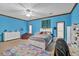 Bright bedroom with bed, dresser, and blue walls, natural light, ceiling fan, and carpet at 2701 East Mill Sw Way, Conyers, GA 30094