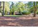 Ranch-style home featuring a manicured front lawn with mature trees and a charming front entrance at 2701 East Mill Sw Way, Conyers, GA 30094