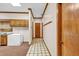 Hallway with tiled floor and coat rack, adjacent to an area with wooden cabinets at 2701 East Mill Sw Way, Conyers, GA 30094