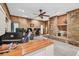 Large living room featuring a stone fireplace, ceiling fan, and multiple workstation areas at 2701 East Mill Sw Way, Conyers, GA 30094
