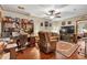Cozy living room featuring hardwood floors, ceiling fan, and comfortable furnishings at 2701 East Mill Sw Way, Conyers, GA 30094