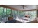 Inviting screened porch with ceiling fan, seating, and views of surrounding trees at 2701 East Mill Sw Way, Conyers, GA 30094